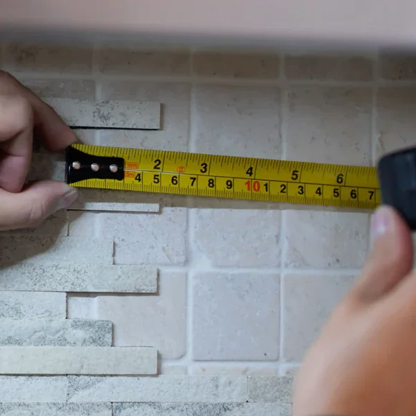 Measuring the thickness of flexible stone veneer with a tape measure